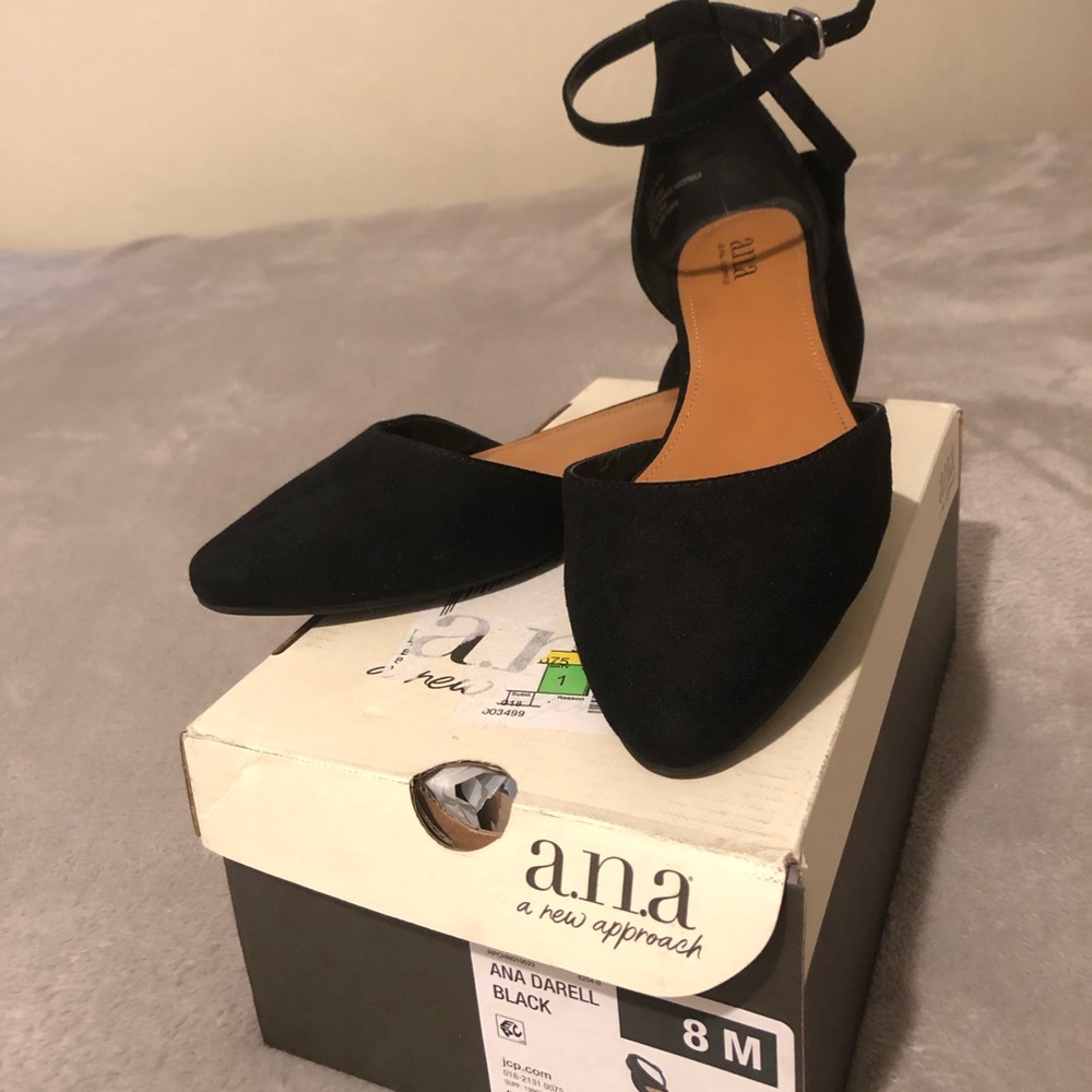 Woman’s black suede flat shoes